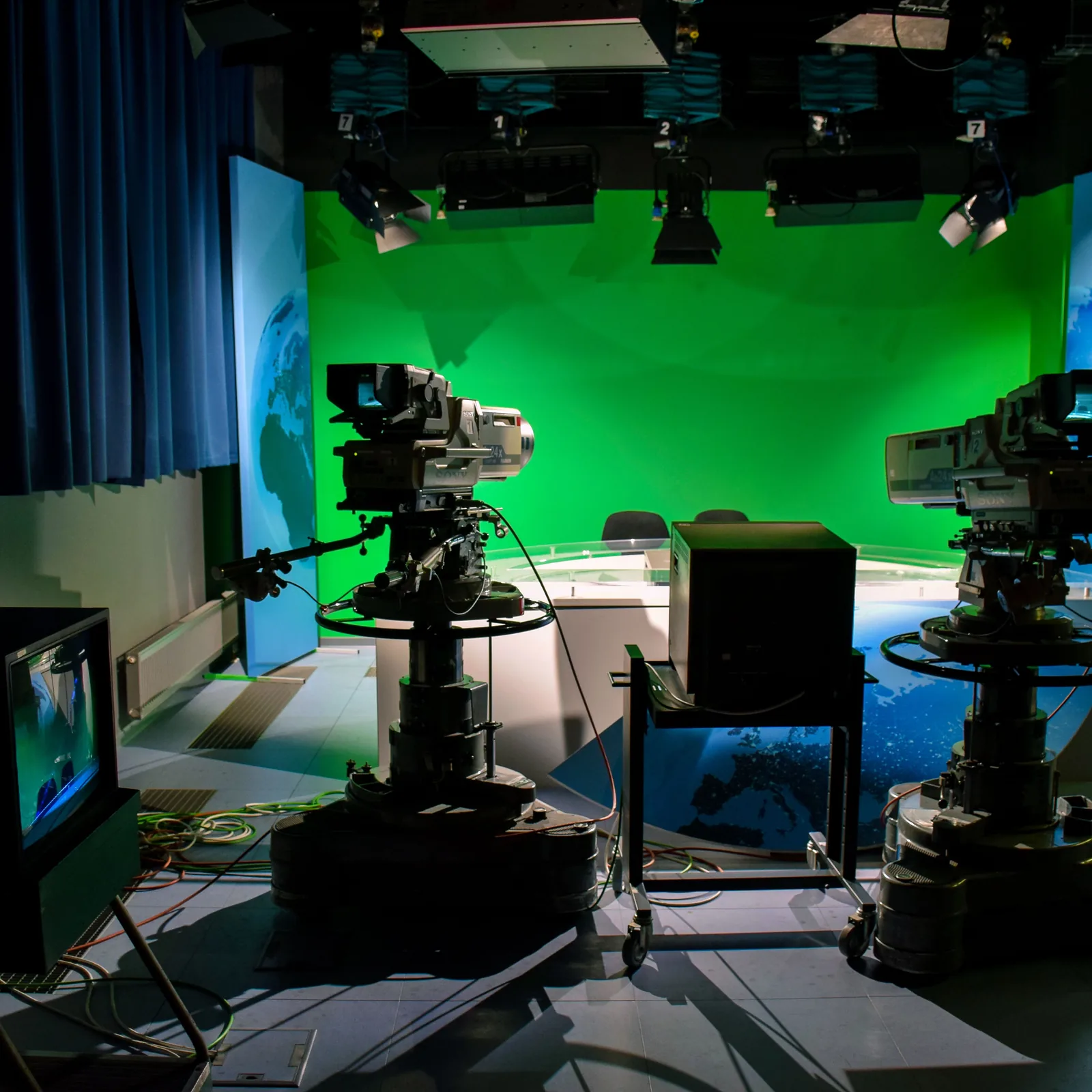 Television studio with cameras, lighting and a presentation desk