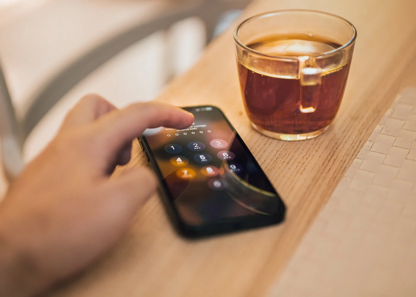 Hand unlocking a smartphone with a screen lock